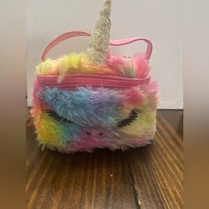 This is a Claire's fuzzy plush rainbow unicorn makeup bag